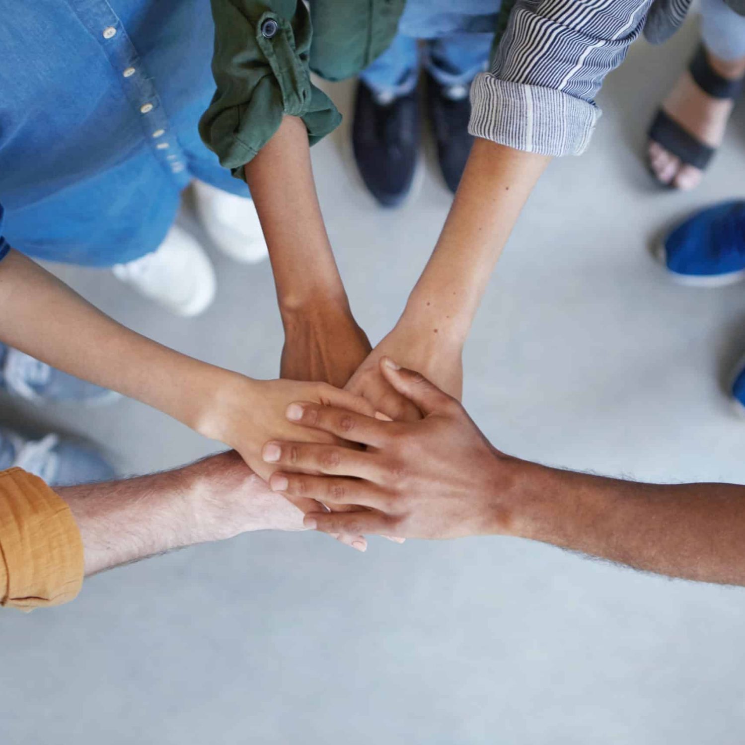 Solidarity and unity conept. Cropped shot of business partners holding their hands together expressing their agreement. True friends keeping their hands together swearing always help each other